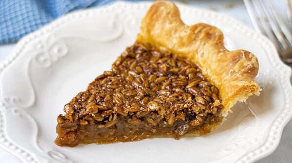 slice of sunflower seed pie on a plate showing off the gooey inside and crunchy top