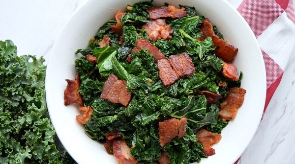 overhead shot of Sauteed Kale with Bacon in a white bowl
