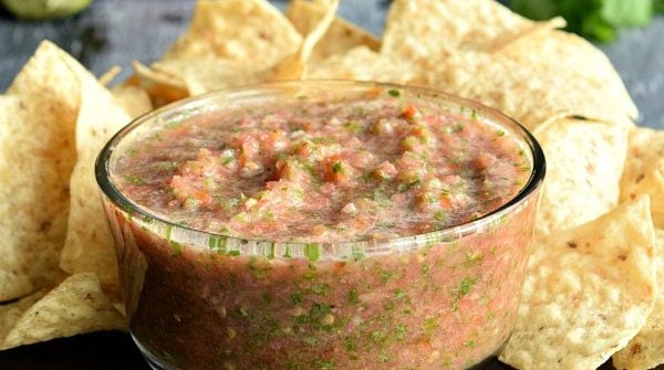 Fresh Restaurant Style Salsa in a bowl next to chips and tomatoes