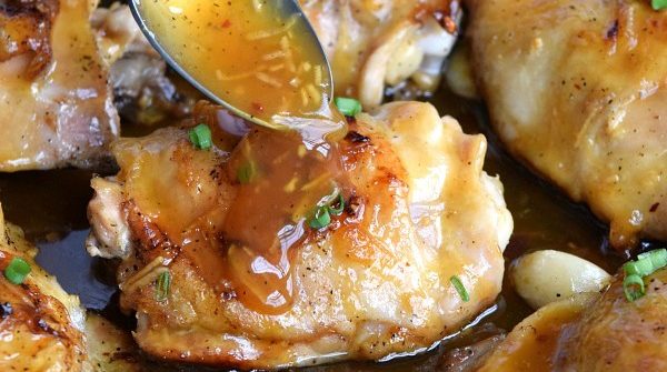 spoonful of Sticky Orange glaze on a Chicken Thigh