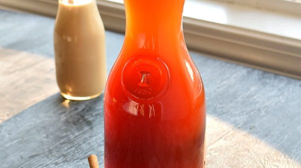Homemade Chai Tea Concentrate sitting next to a window