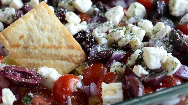 Pita Chip dipped into Greek Layer Dip