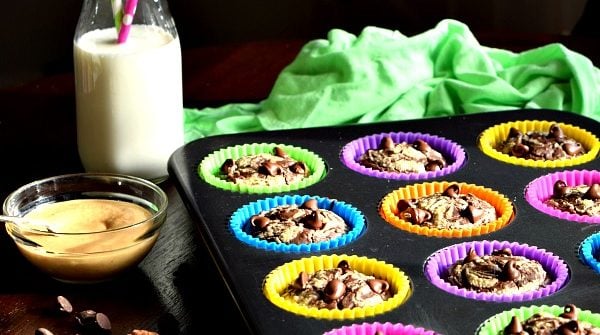 Chocolate Peanut Butter Muffins in a tin with milk on the table