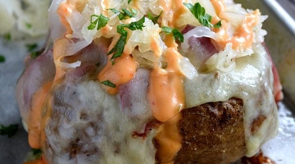 Reuben Stuffed Baked Potato covered with sauerkraut and dripping with 1,000 island dressing