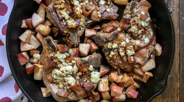 Overhead Shot of Apple Bacon Blue Smothered Pork Chops in a cast iron skillet