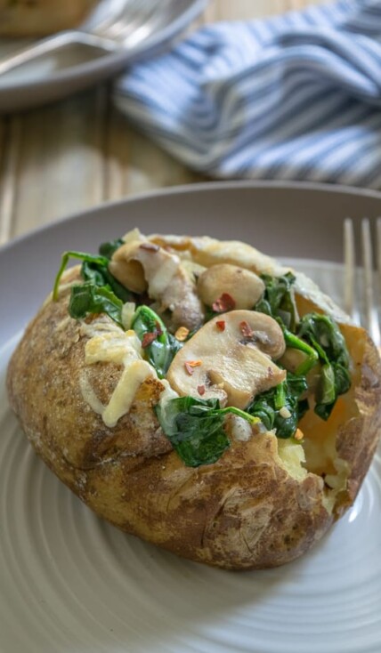 Spinach Mushroom Stuffed Baked Potatoes on a plate with a fork