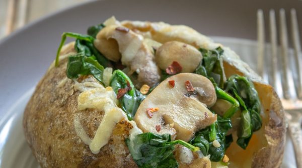Spinach Mushroom Stuffed Baked Potatoes on a plate with a fork