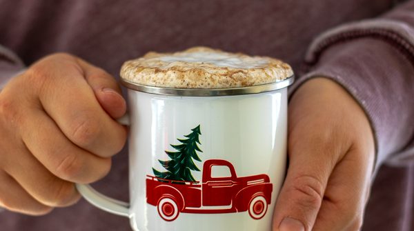 a person holding a skinny gingerbread tea latte