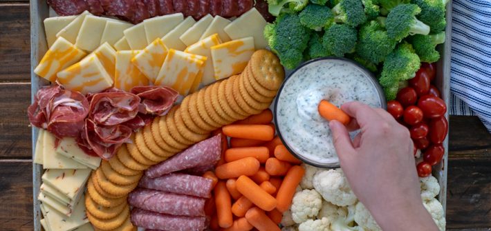 dipping into a dip on a snack platter