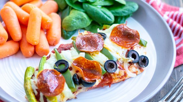 a serving f the supreme pizza chicken on a plate with sides