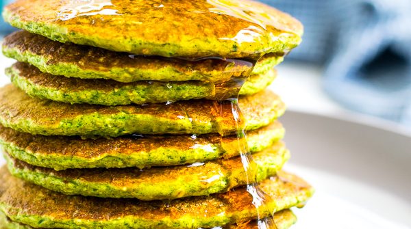 close picture of a stack of green oatmeal packs with syrup drizzling down the side