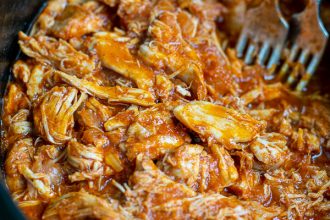 close up of pulled bbq chicken in the slow cooker