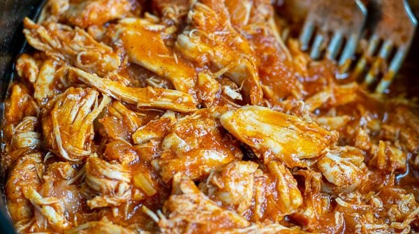 close up of pulled bbq chicken in the slow cooker