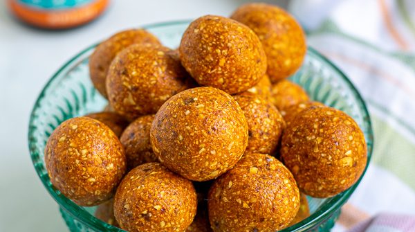 a blue bowl full of easy tropical energy bites