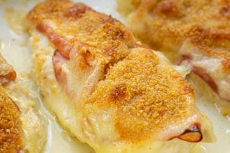 close up of a chicken cordon bleu baked chicken in a casserole dish
