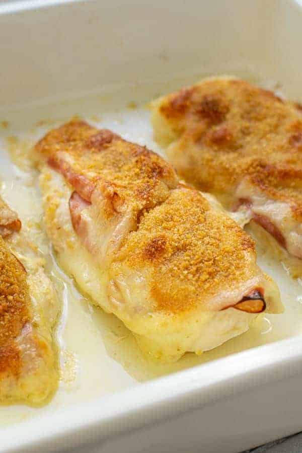 Close up of a chicken cordon bleu baked chicken in a casserole dish.