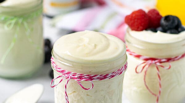 light and airy lemon whipped greek yogurt in a jar with a pink string