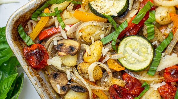 corner of a baked gnocchi and vegetables sheet pan meal