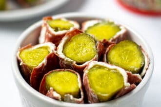 white bowl full of dried beef pickle roll ups