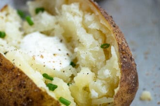 Baked Potato made in the pressure cooker sliced open revealing fluffy perfectly cooked inside