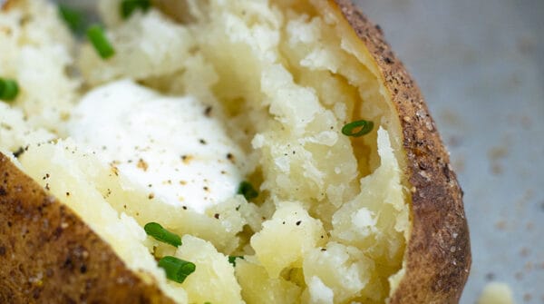 Baked Potato made in the pressure cooker sliced open revealing fluffy perfectly cooked inside