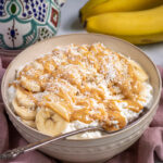 Pinterest Pin with text overlay ' Peanut Butter & Banana Cottage Cheese Bowl', image of bowl filled with cottage cheese, banana slices, and drizzled peanut butter.