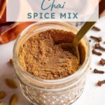 Pinterest pin with text overlay 'Chai Spice Mix', image of jar filled with spice blend and a spoon.