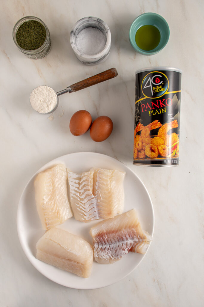 Ingredients for baked breaded cod laid out on a table.