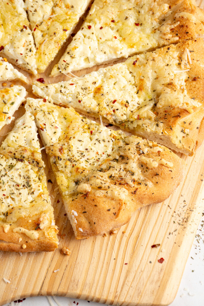 A close up of a slice of white pizza.