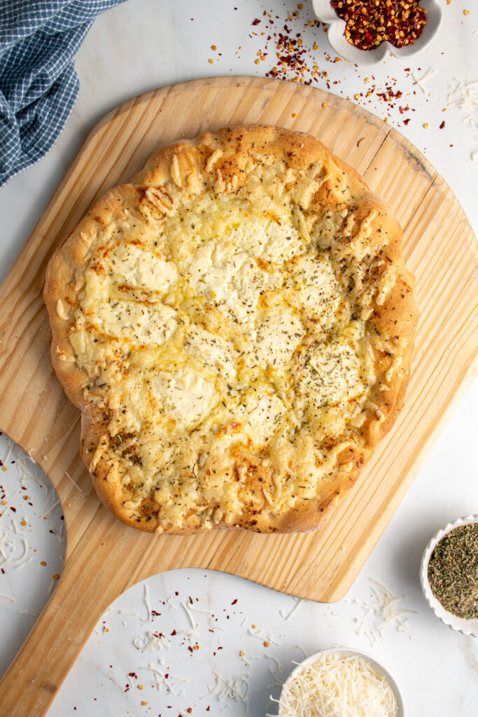 A white pizza on a pizza peel.
