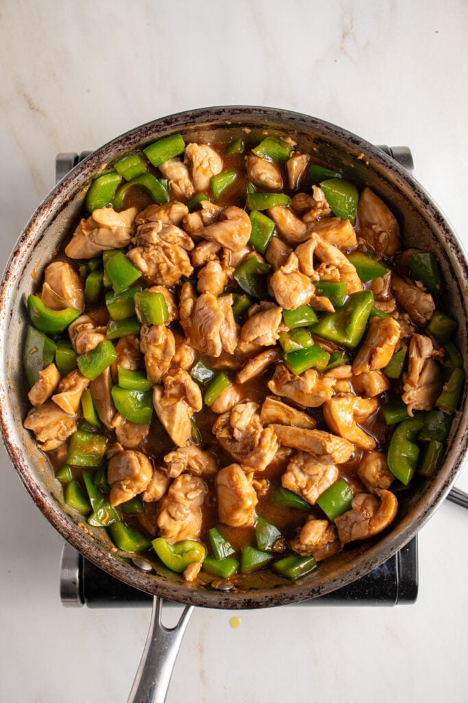 Cooking the chicken bell pepper stir fry with sauce.