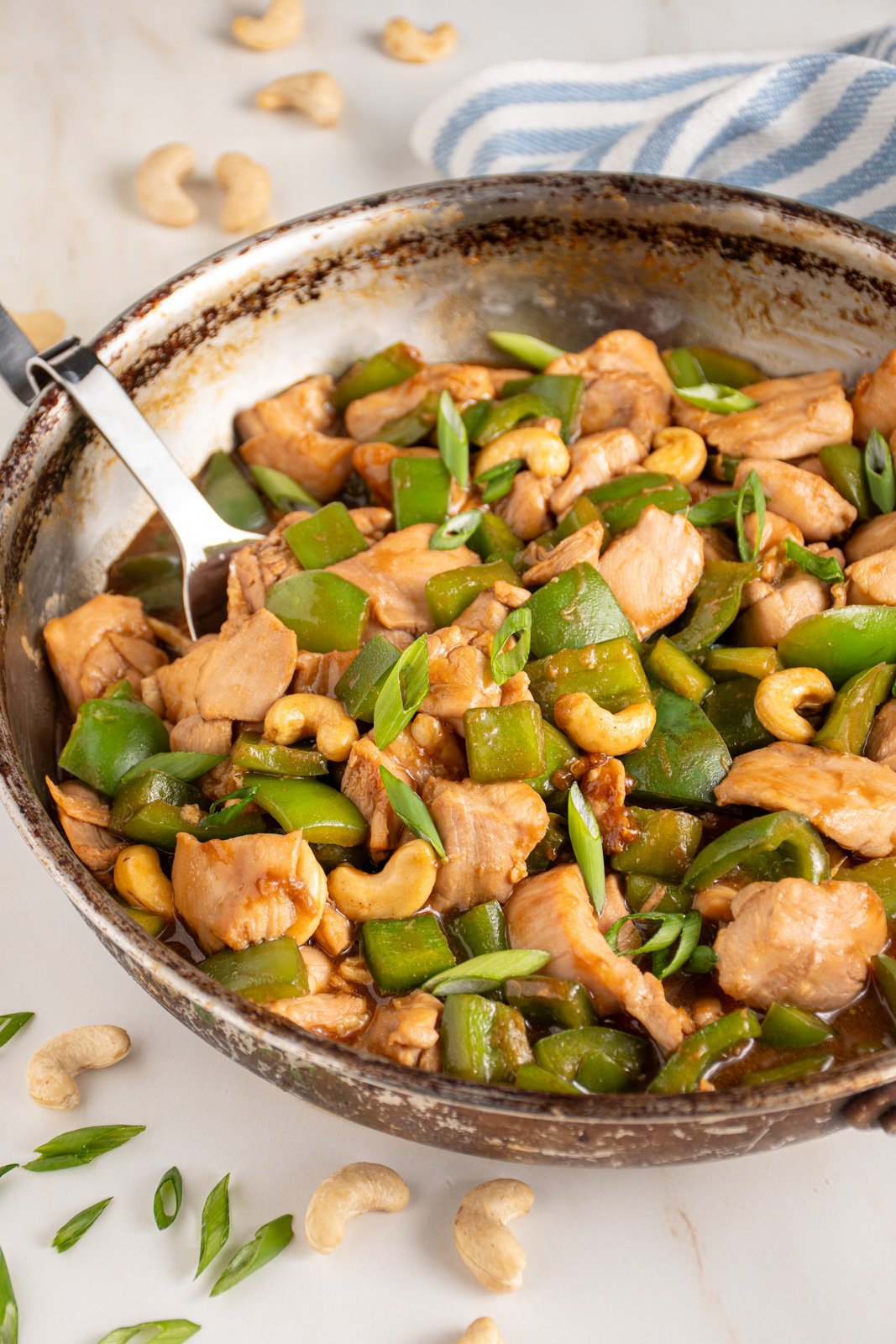 Skillet with chicken bell pepper stir fry.