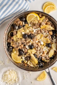 A skillet with ground turkey, black olives, beans, artichoke hearts, and feta cheese.