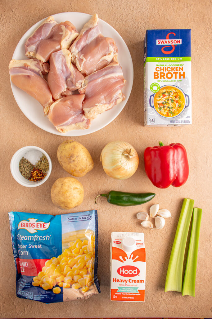 Ingredients on a tabletop for making crockpot chicken and corn chowder.