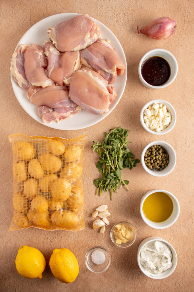 Ingredients for making sheet pan balsamic chicken thighs laid out on a tabletop.