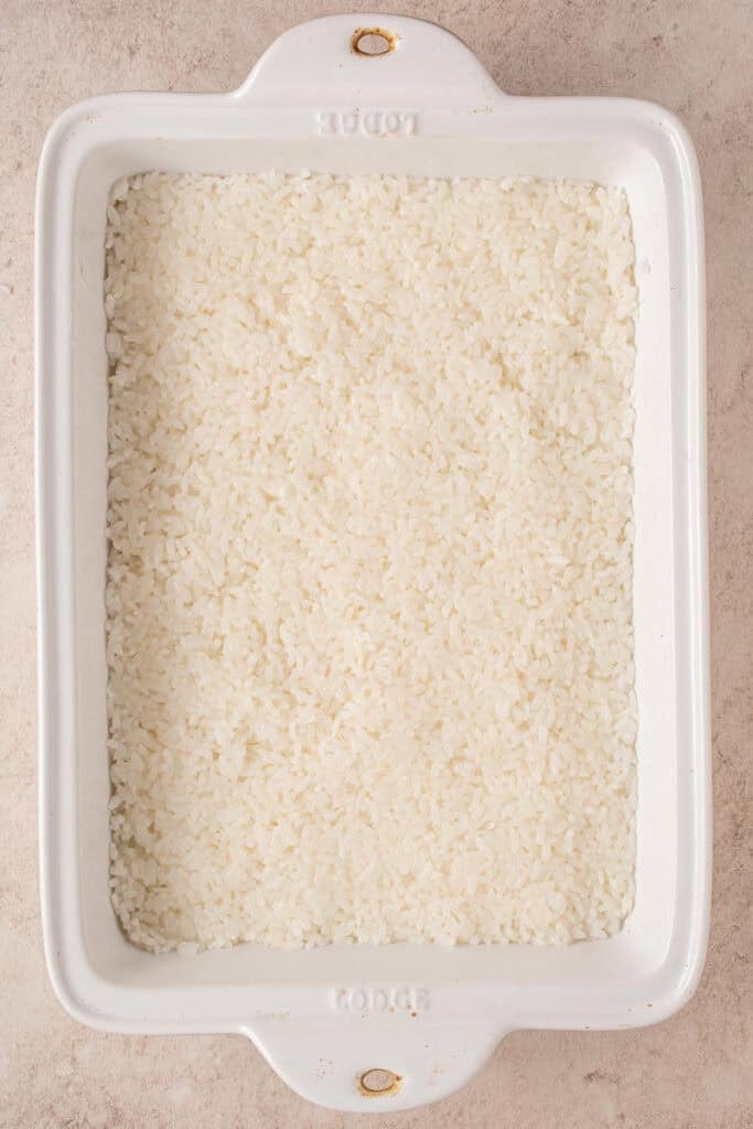 Rice pressed into the casserole dish.