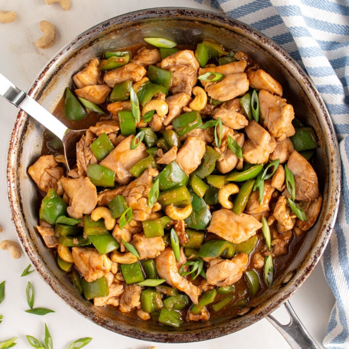 Skillet filled with chicken bell pepper stir fry.