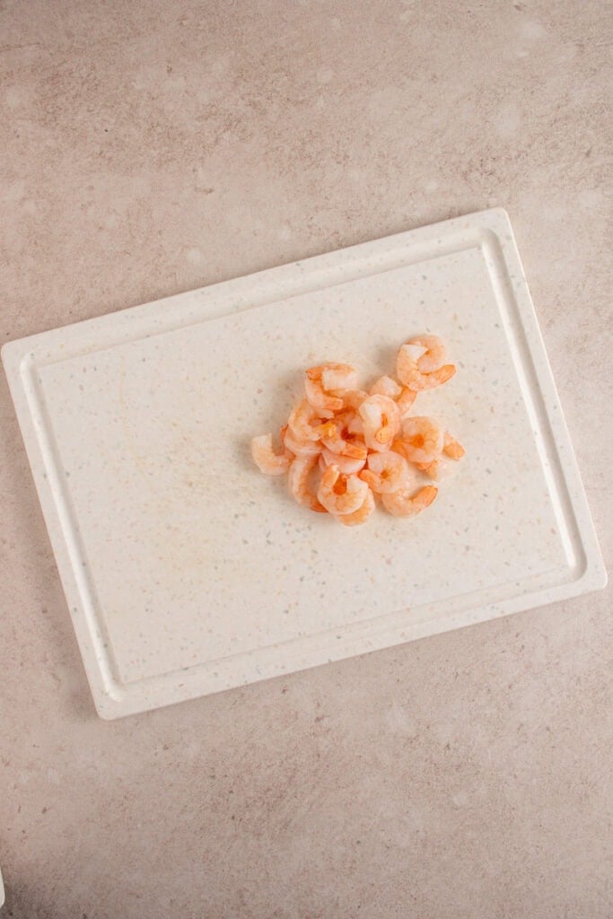 Shrimp on a cutting board.
