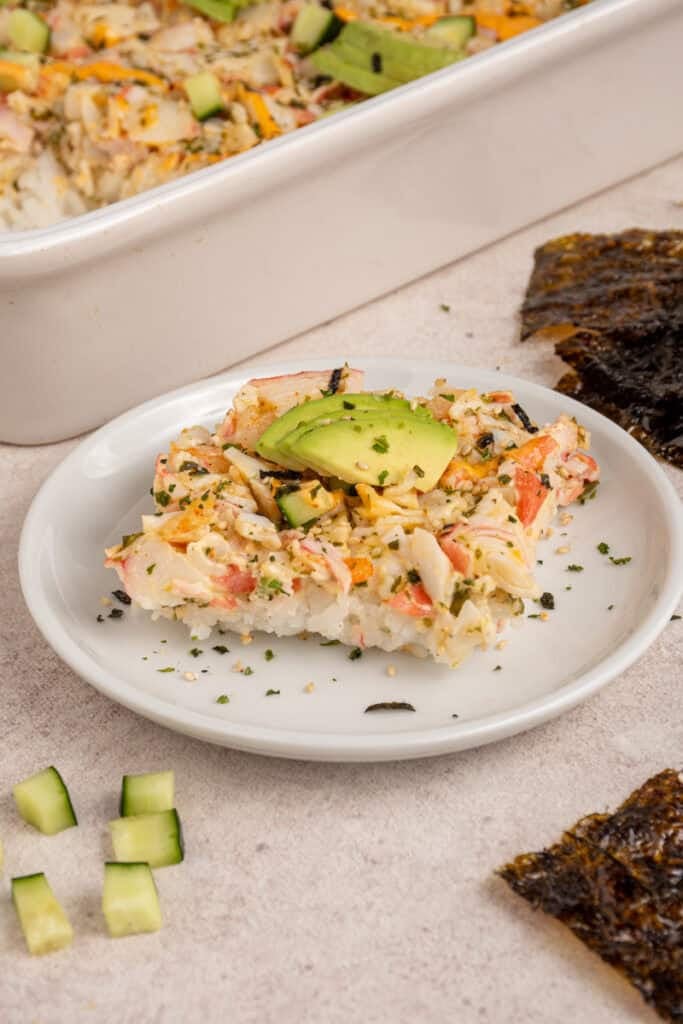 A slice of shrimp and sushi bake on a plate.