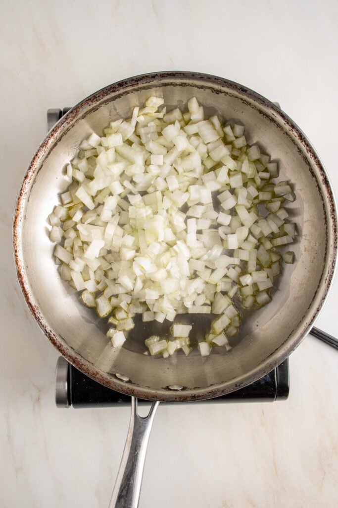 Diced onions and olive oil in a skillet.