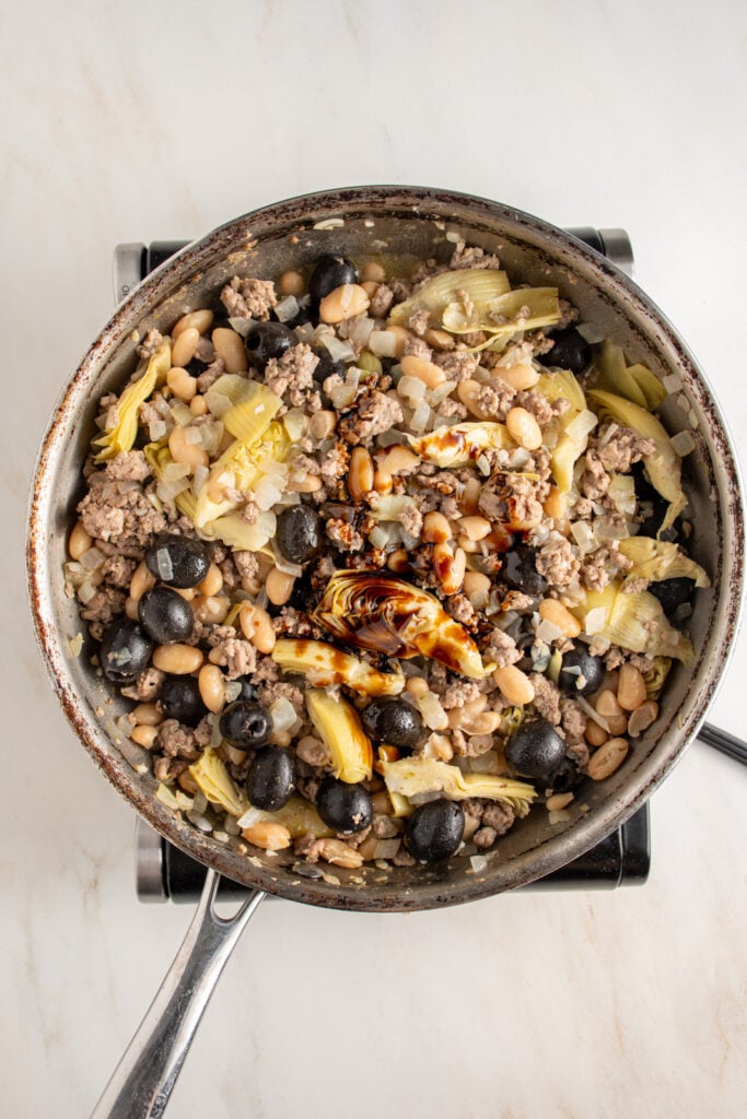 Balsamic and lemon being added to the mediterranean turkey skillet.