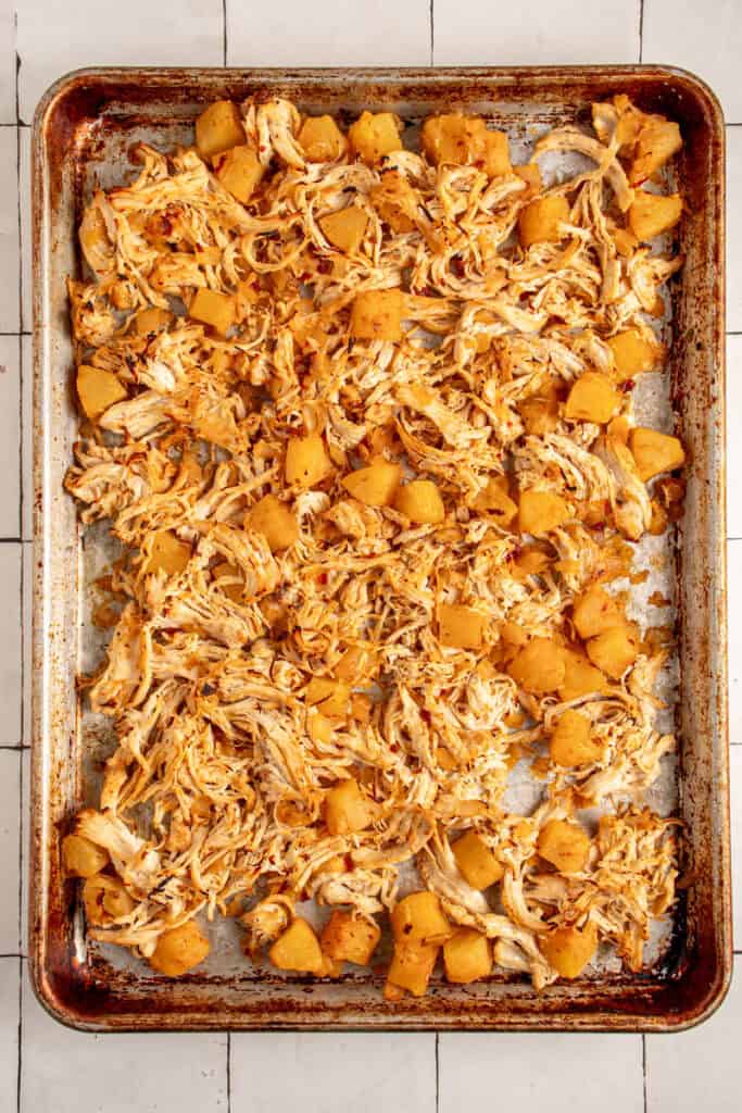 Broiled chicken and pineapples on a sheet pan.