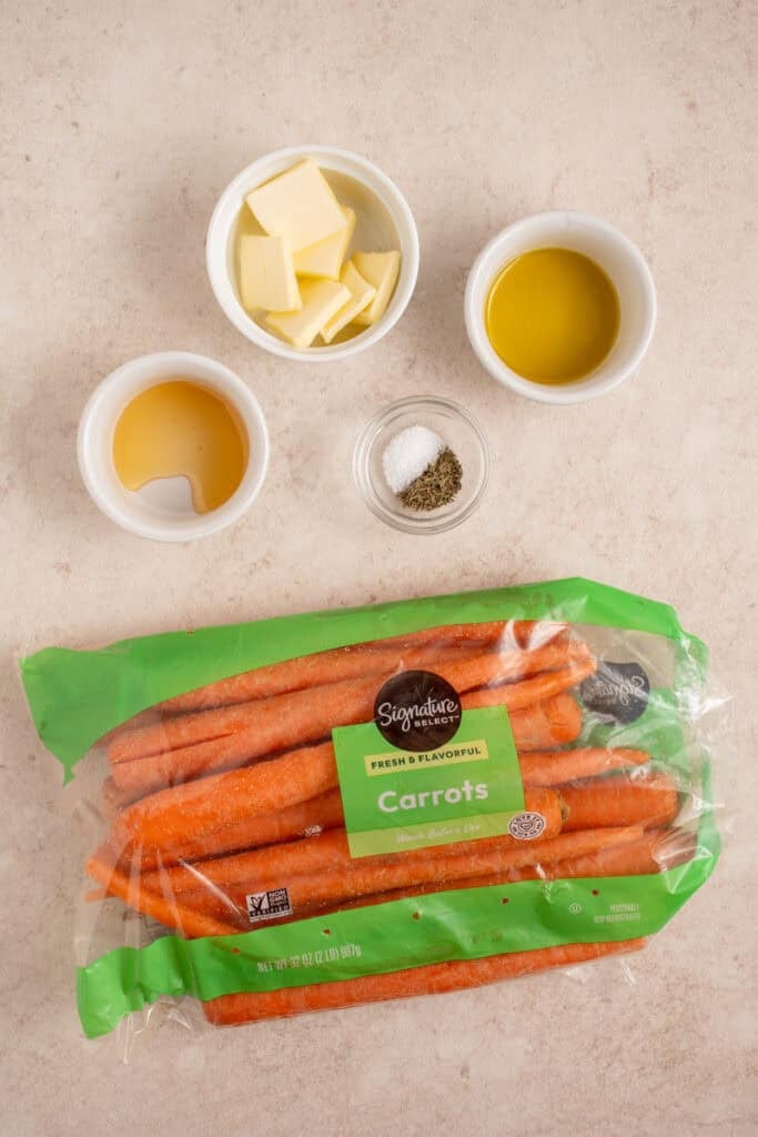 Ingredients to make crockpot carrots on a tabletop.