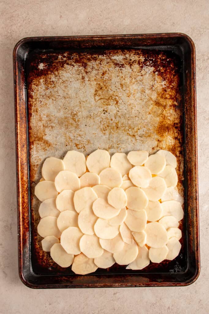 A second layer of potatoes on a sheet pan.