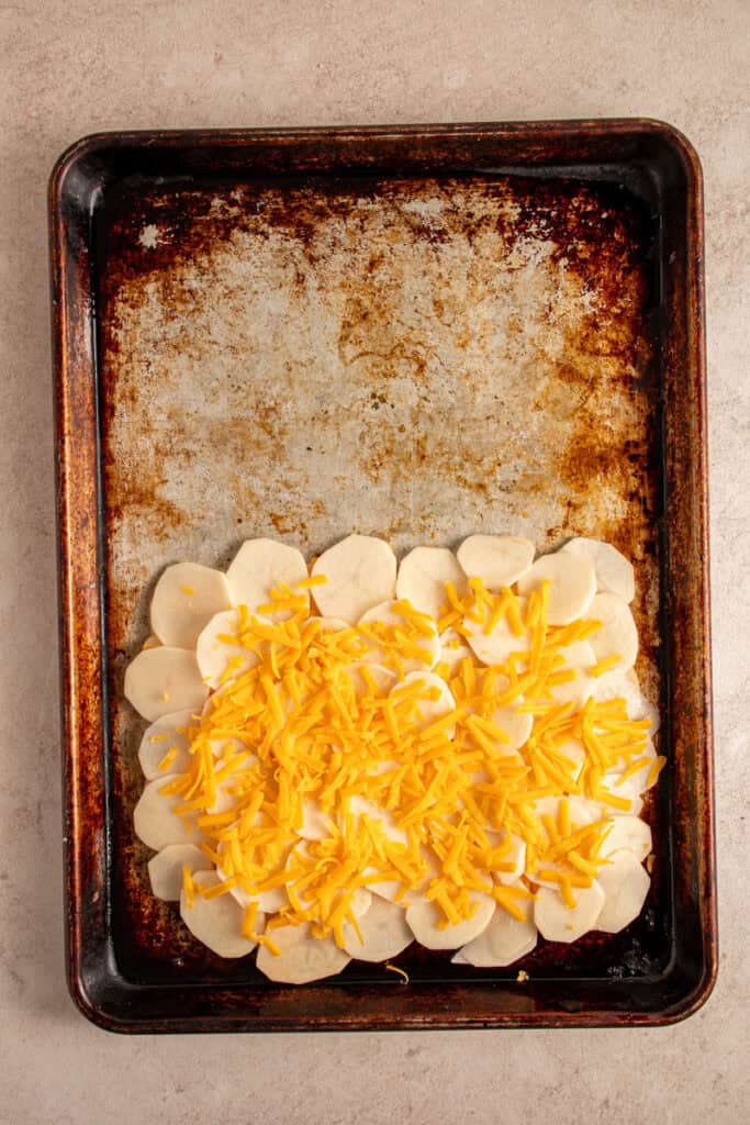 Shredded cheese on a second layer of potatoes.