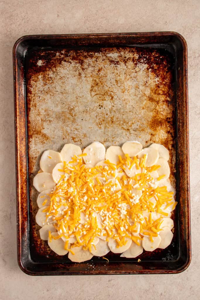 Half and half mixture on a second layer of potatoes and shredded cheese.