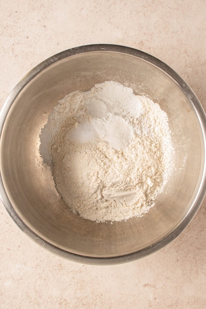 A bowl with flour, salt, sugar, and baking powder.
