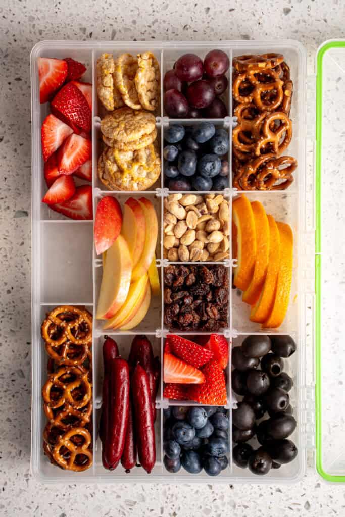 A snackle box filled with food.
