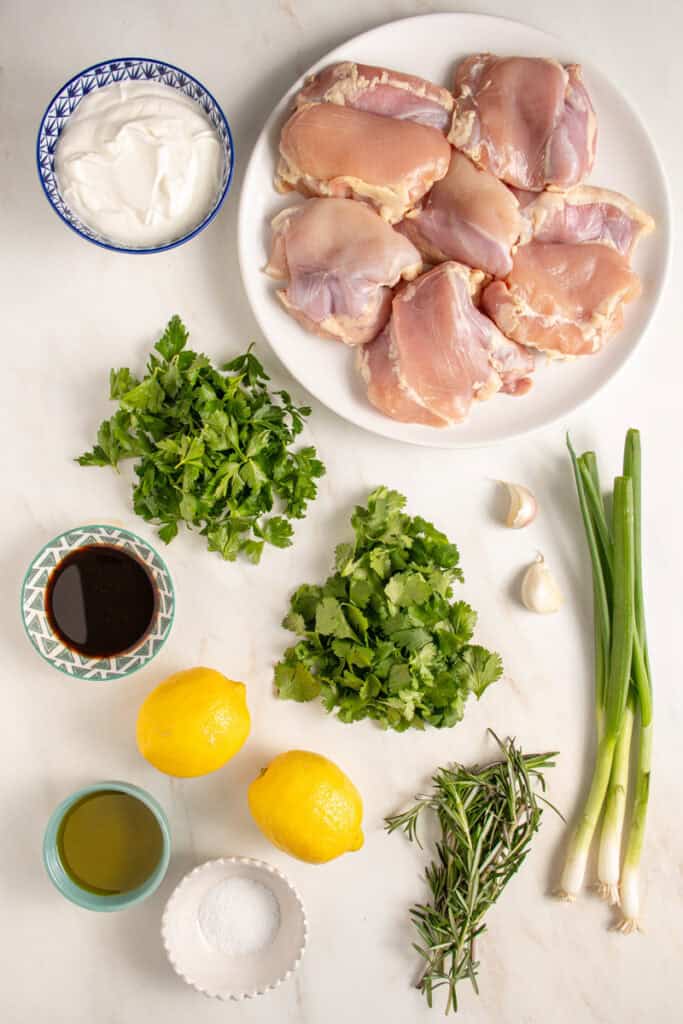 Ingredients to make green goddess chicken thighs laid out on a tabletop.