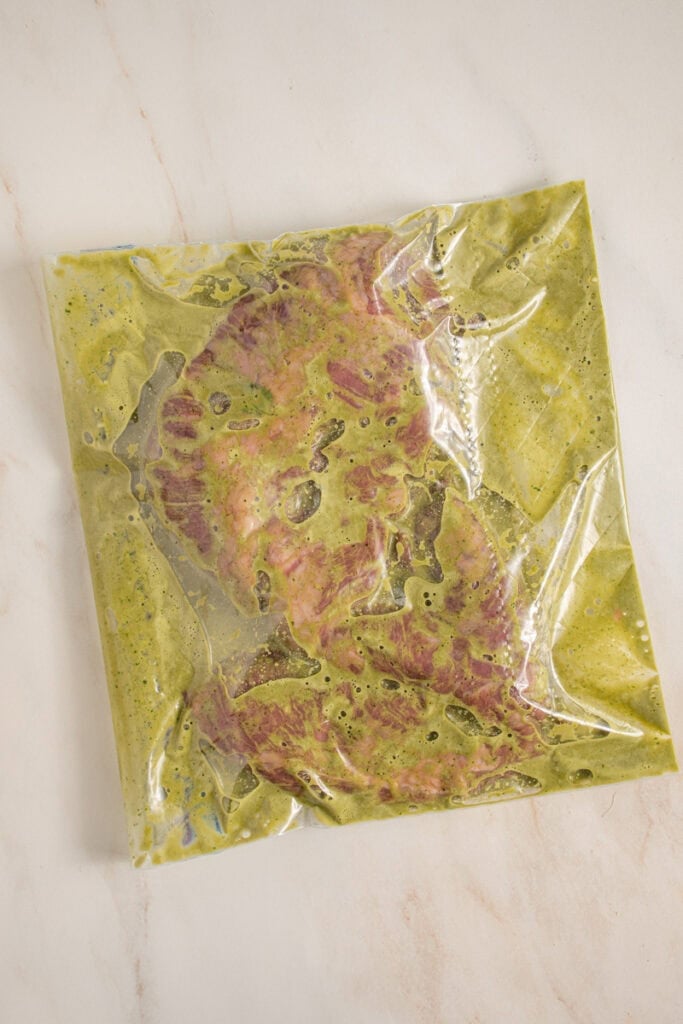 A zip top bag with skirt steak and marinade.